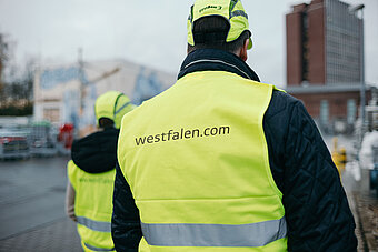 Westfalen Mitarbeiter mit gelber Warnweste läuft auf Westfalen Gelände
