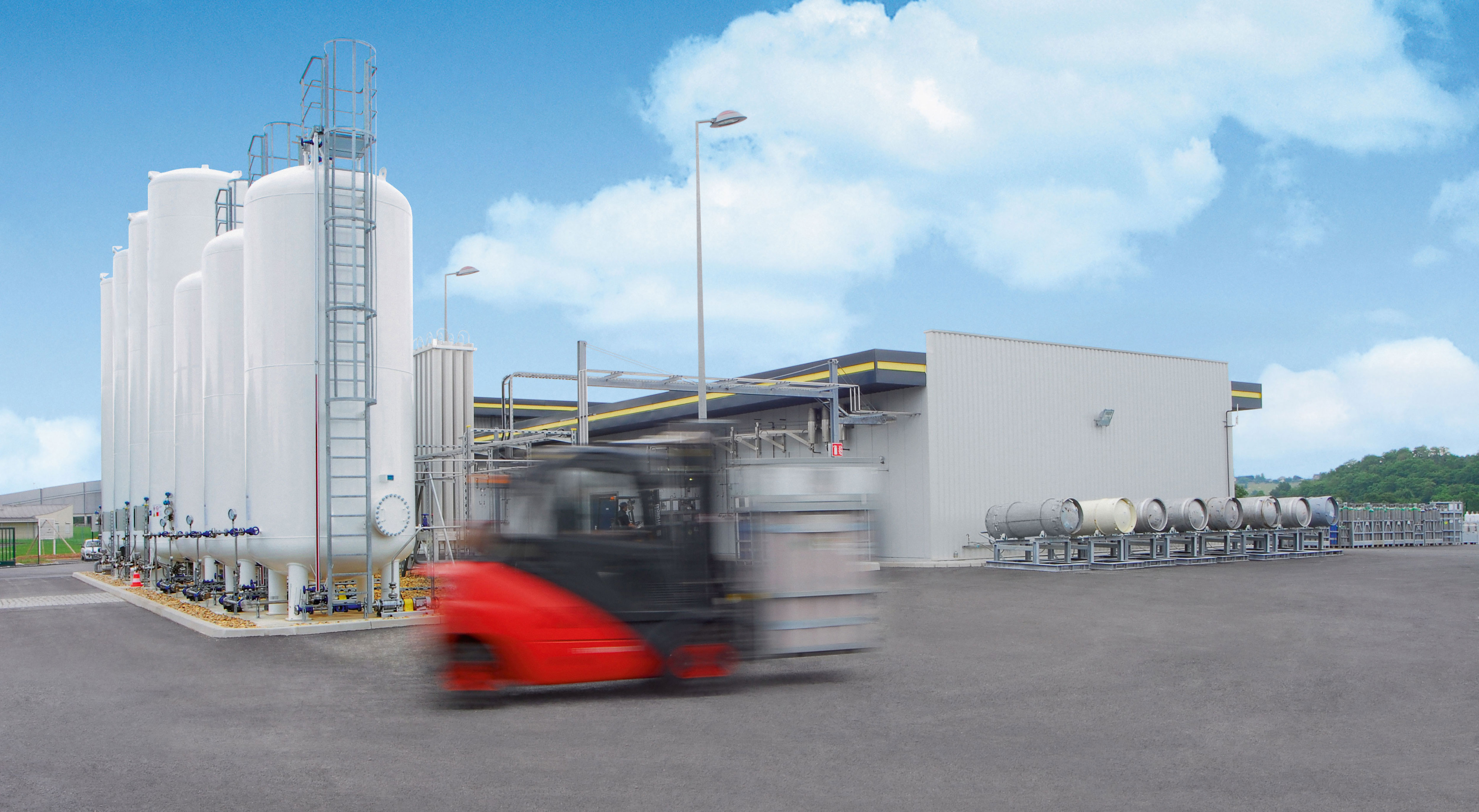 Stapler fährt auf Firmengelände vor Gas-Hochtanks